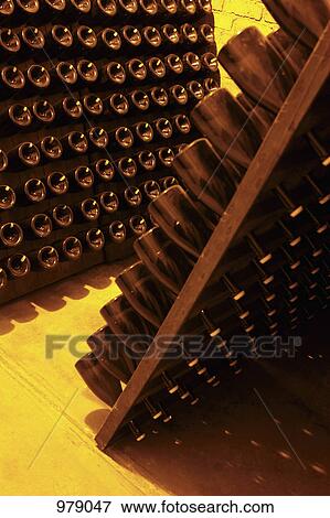 Detail of bottles of champagne in racks at a winery View Large Photo Image Stock Photo - Detail of bottles of champagne in racks at a winery. Fotosearch