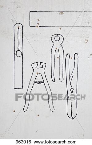 Detail of drawn outlines of hand tools on a wall View Large Photo Image Stock Photograph - Detail of drawn outlines of hand tools on a wall. Fotosearch