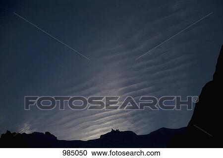 Stock Image - Detail of mountains in silhouette and clouds in the sky, Torres del Paine National Park, Chile. Fotosearch