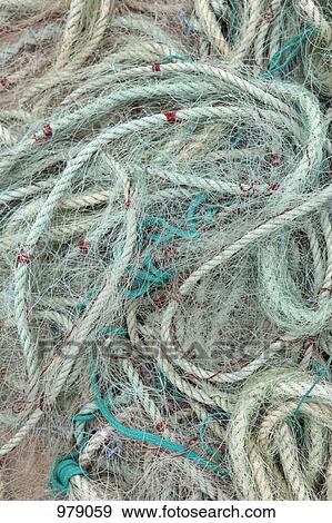 Stock Photo - Detail of ropes and fishing nets on the ground. Fotosearch