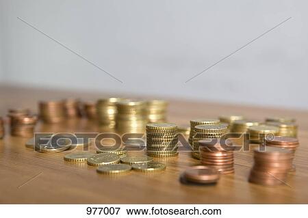 Euro coins on a wooden table View Large Photo Image Stock Photo - Euro coins on a wooden table. Fotosearch