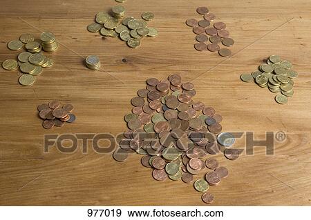 Euro coins on a wooden table View Large Photo Image Stock Photo - Euro coins on a wooden table. Fotosearch
