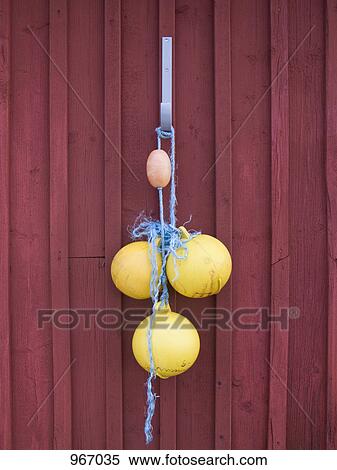 Stock Photography - Floats hanging from a hook. Fotosearch