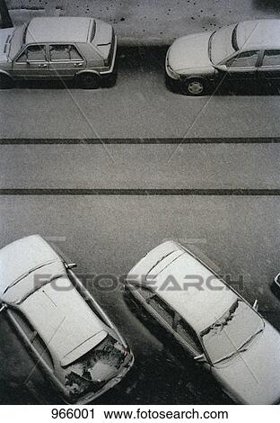 Four cars covered in snow on a street View Large Photo Image Stock Image - Four cars covered in snow on a street. Fotosearch