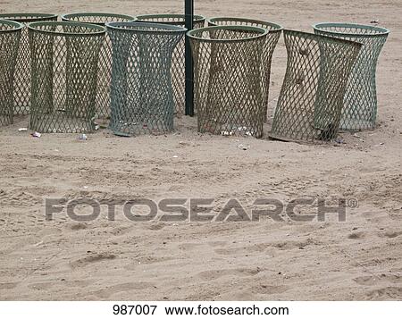 Stock Photo - Garbage cans in a row at the beach. Fotosearch