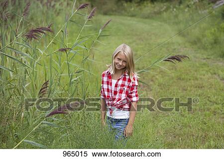 Girl in a meadow View Large Photo Image Stock Photography - Girl in a meadow. Fotosearch