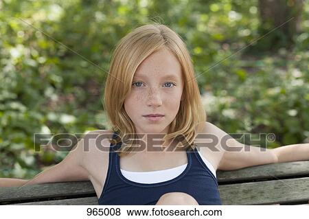 Girl on a bench View Large Photo Image Stock Photo - Girl on a bench. Fotosearch