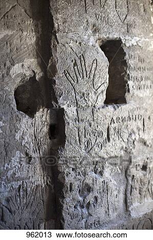 Handprints and handwritten graffiti etched into a stone wall View Large Photo Image Stock Image - Handprints and handwritten graffiti etched into a stone wall. Fotosearch