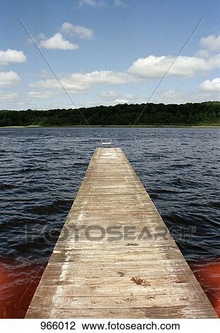 Stock Image - Jetty leading into a lake. Fotosearch