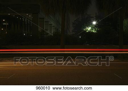 Stock Image - Light trails on a city street. Fotosearch