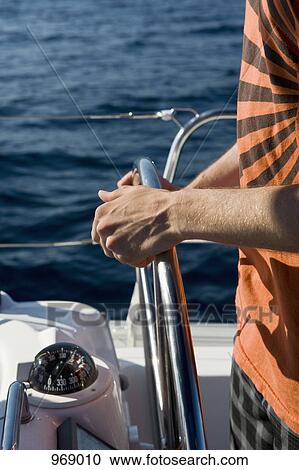Man at the helm of a yacht View Large Photo Image Stock Image - Man at the helm of a yacht. Fotosearch