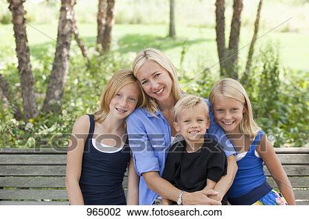 Stock Image - Mom and kids on a bench. Fotosearch