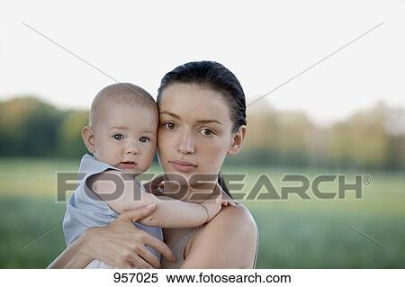 Mother holding baby in nature View Large Photo Image Stock Photography - Mother holding baby in nature . Fotosearch