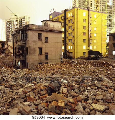 Picture - Old dilapidated buildings and rubble with modern buildings in background, Shenzhen, China. Fotosearch