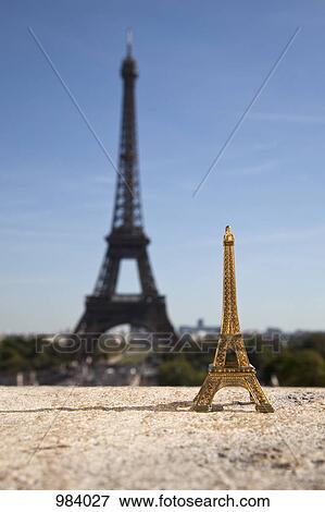 One Eiffel Tower replica souvenir next to the real Eiffel Tower, focus on foreground View Large Photo Image Stock Photo - One Eiffel Tower replica souvenir next to the real Eiffel Tower, focus on foreground . Fotosearch