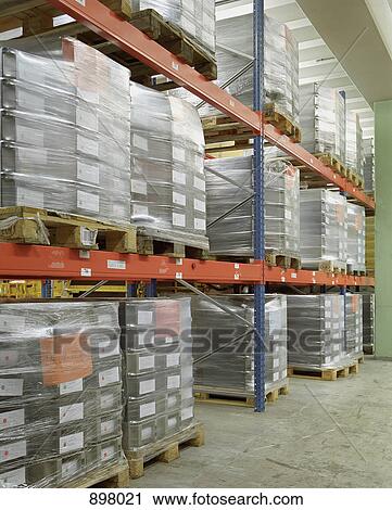 Pallets stacked in a warehouse View Large Photo Image Stock Image - Pallets stacked in a warehouse. Fotosearch