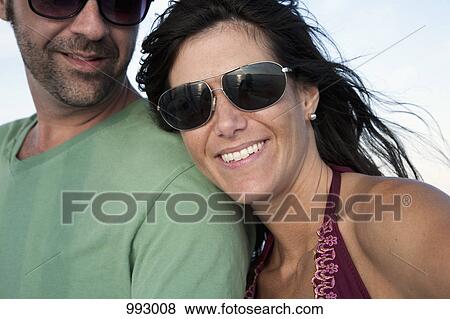 Portrait of a couple enjoying summer, outdoors View Large Photo Image Stock Photo - Portrait of a couple enjoying summer, outdoors. Fotosearch