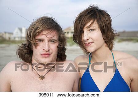 Stock Image - Portrait of a young couple at the beach. Fotosearch