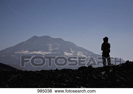 Rear view of a woman looking at a mountain view, Lonquimay Volcano, Patagonia, Chile View Large Photo Image Stock Photo - Rear view of a woman looking at a mountain view, Lonquimay Volcano, Patagonia, Chile. Fotosearch