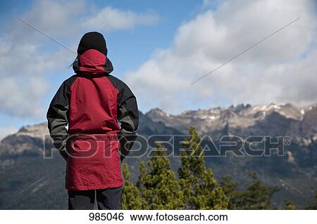 Stock Photograph - Rear view of a woman looking at a mountain view, Patagonia, Chile. Fotosearch
