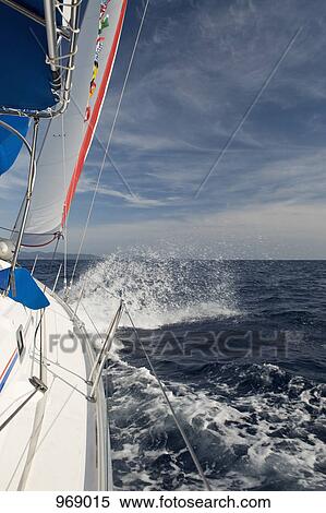 Sailing on waves on a sunny day View Large Photo Image Stock Photography - Sailing on waves on a sunny day. Fotosearch