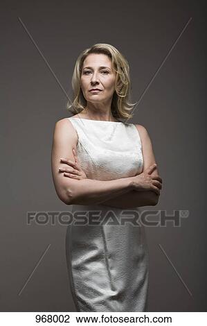 Serious woman in white dress View Large Photo Image Stock Image - Serious woman in white dress . Fotosearch