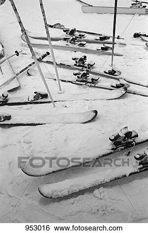Skis and ski poles in the snow View Large Photo Image Stock Photograph - Skis and ski poles in the snow. Fotosearch