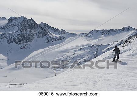 Snowboarder preparing to go down a slope View Large Photo Image Stock Photograph - Snowboarder preparing to go down a slope. Fotosearch