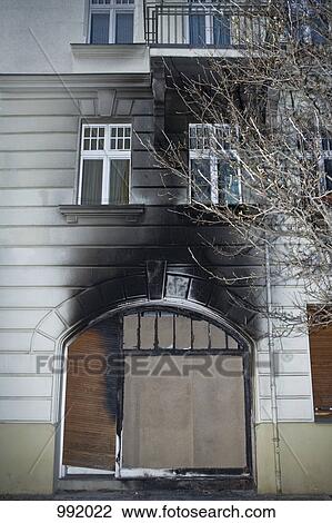 The front of a boarded up building after a fire View Large Photo Image Stock Image - The front of a boarded up building after a fire. Fotosearch