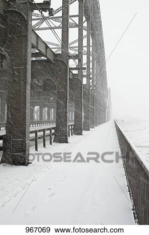 The metal structure of a bridge in a snowstorm View Large Photo Image Stock Photo - The metal structure of a bridge in a snowstorm. Fotosearch