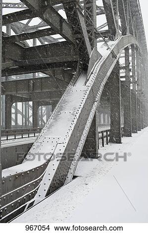 The metal structure of a road bridge in a snowstorm View Large Photo Image Picture - The metal structure of a road bridge in a snowstorm. Fotosearch