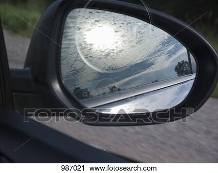 The reflection of the sky in a car side-view mirror View Large Photo Image Stock Image - The reflection of the sky in a car side-view mirror. Fotosearch