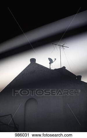 The roof of a house with a satellite dish on it View Large Photo Image Stock Image - The roof of a house with a satellite dish on it. Fotosearch