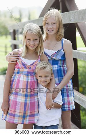 Three kids on a bridge View Large Photo Image Stock Image - Three kids on a bridge . Fotosearch