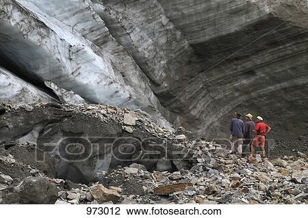 Three men standing at the foot of a glacier View Large Photo Image Stock Image - Three men standing at the foot of a glacier. Fotosearch