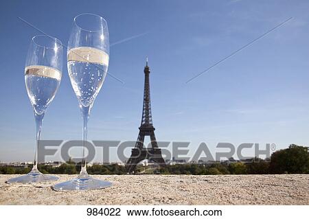 Two champagne flutes in front of the Eiffel Tower, focus on foreground View Large Photo Image Stock Image - Two champagne flutes in front of the Eiffel Tower, focus on foreground. Fotosearch