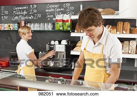 Two employees working in a bakery cafe View Large Photo Image Stock Image - Two employees working in a bakery cafe. Fotosearch