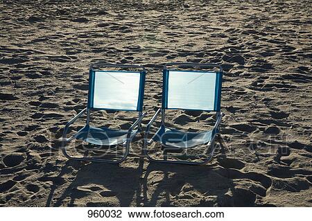 Two empty chairs on a beach View Large Photo Image Stock Image - Two empty chairs on a beach. Fotosearch