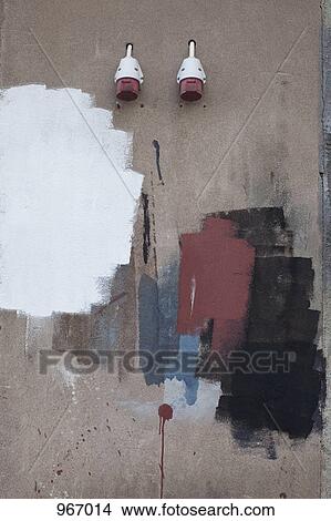 Two exterior plug sockets coming out of a wall with paint swatches View Large Photo Image Picture - Two exterior plug sockets coming out of a wall with paint swatches. Fotosearch