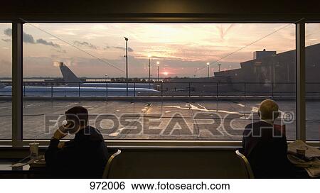 Two men waiting at the airport View Large Photo Image Stock Photograph - Two men waiting at the airport. Fotosearch