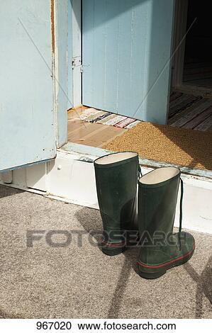 Two wellington boots in front of an open door View Large Photo Image Stock Image - Two wellington boots in front of an open door. Fotosearch