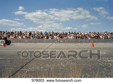 Stock Image - View of a crowd at a race track. Fotosearch