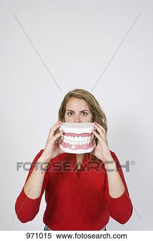 Woman holding large closed teeth View Large Photo Image Stock Photography - Woman holding large closed teeth . Fotosearch