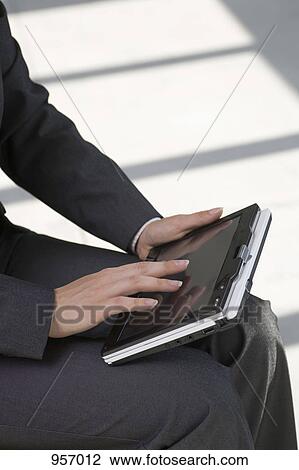 Woman holding tablet PC on lap View Large Photo Image Stock Image - Woman holding tablet PC on lap. Fotosearch