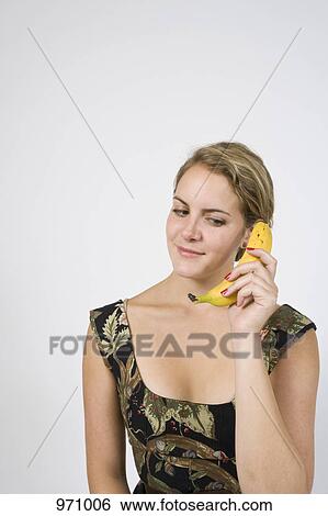 Woman on banana phone looking down View Large Photo Image Stock Photograph - Woman on banana phone looking down. Fotosearch