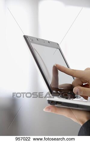 Stock Image - Woman pointing to tablet computer. Fotosearch