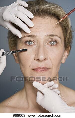 Woman thinking about plastic surgery, Close-up View Large Photo Image Stock Image - Woman thinking about plastic surgery, Close-up. Fotosearch