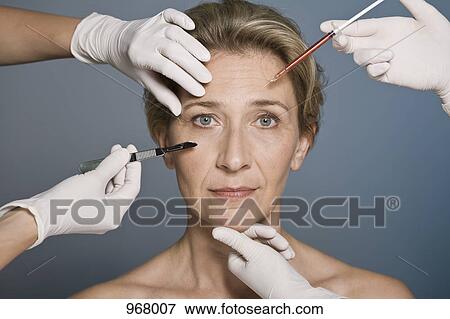 Woman thinking about plastic surgery View Large Photo Image Stock Photo - Woman thinking about plastic surgery . Fotosearch