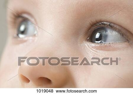 Stock Photo - A baby boy after a crying tantrum, extreme close up of eyes. Fotosearch