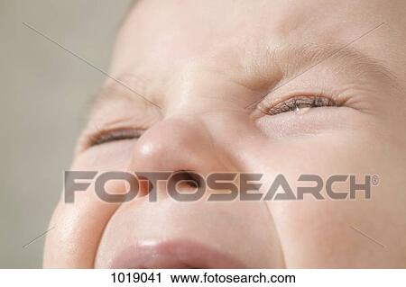 Stock Image - A baby boy crying, extreme close up of face. Fotosearch